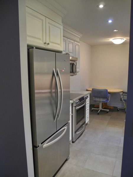 The kitchen has stainless steel appliances and a built-in microwave oven